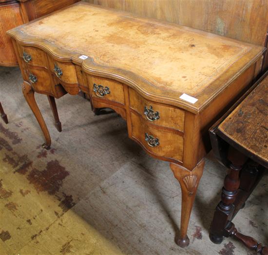 Walnut serpentine front writing table